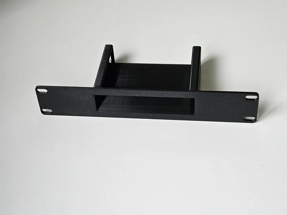One black custom 10-inch rack adapter with a fitted equipment opening and mounting slots.