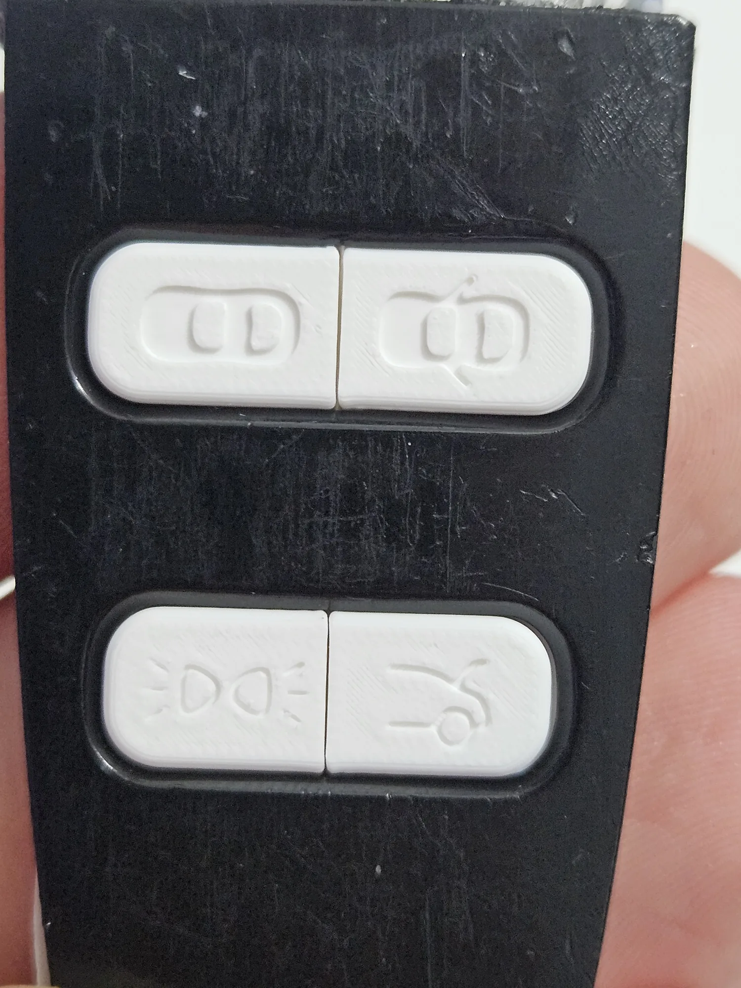 Test-fit white prototype buttons installed in the key frame.