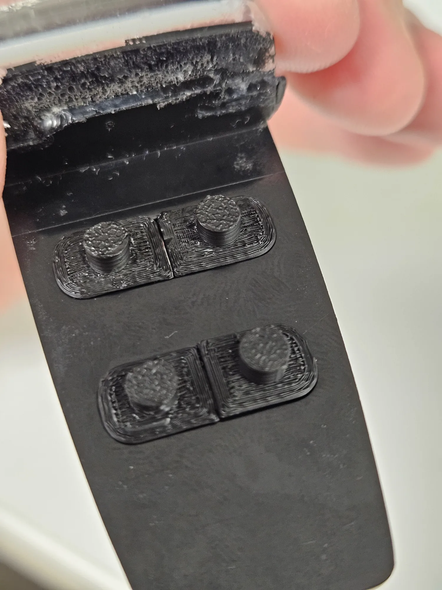 Rear view of the replacement buttons showing the integrated plungers.