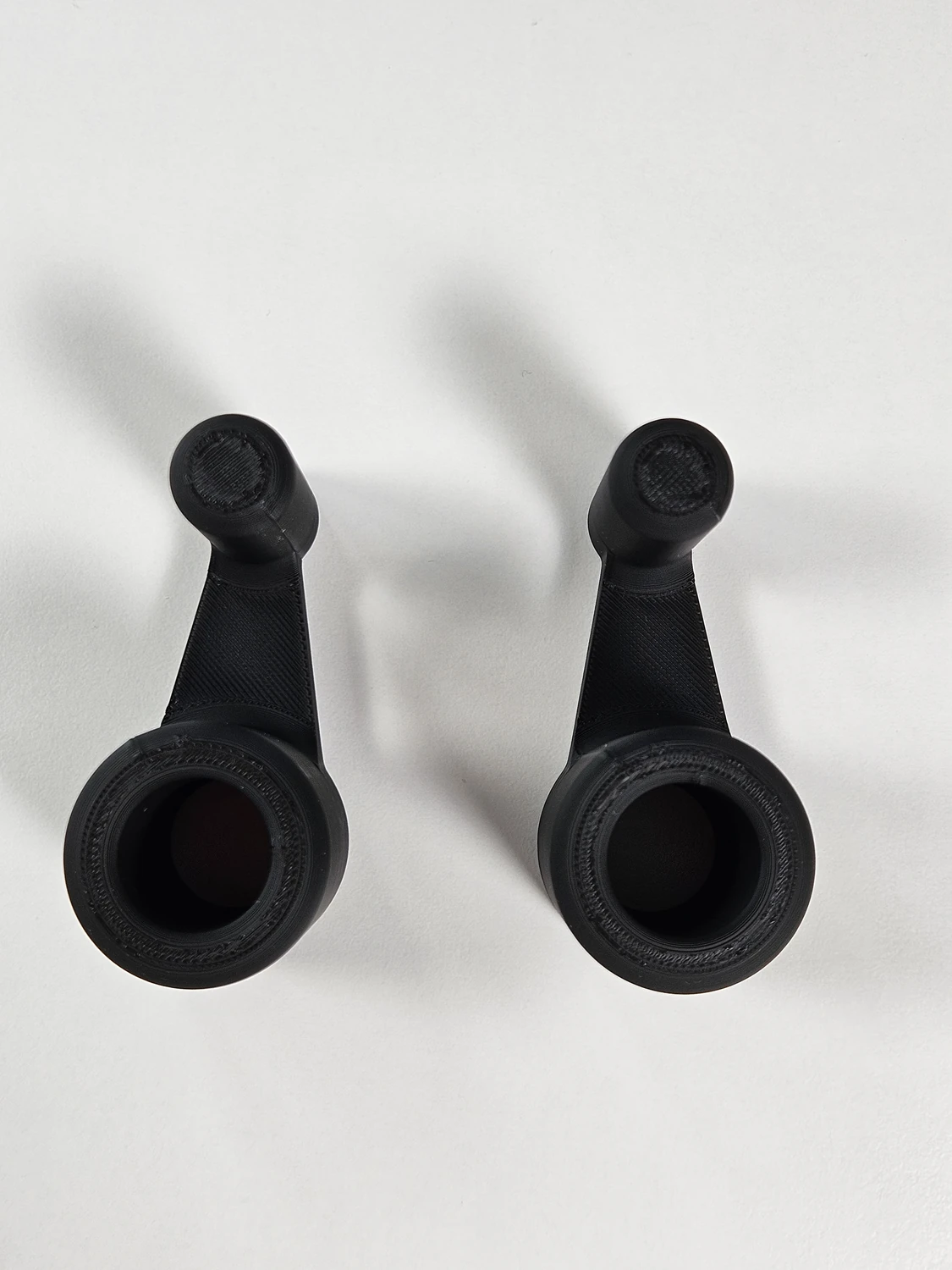 Large black laptop riser feet shown from above.