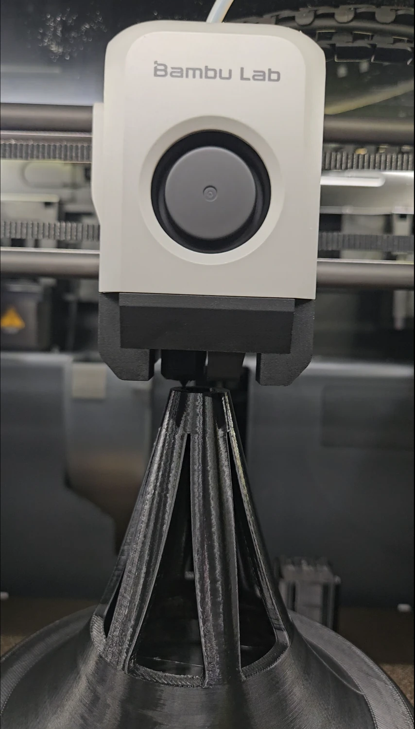 Custom PETG roof vent cowl near the end of the print on the printer bed.