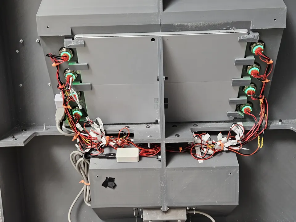 Closer rear view of the tablet, routed wiring and small controller housing in the finished assembly.
