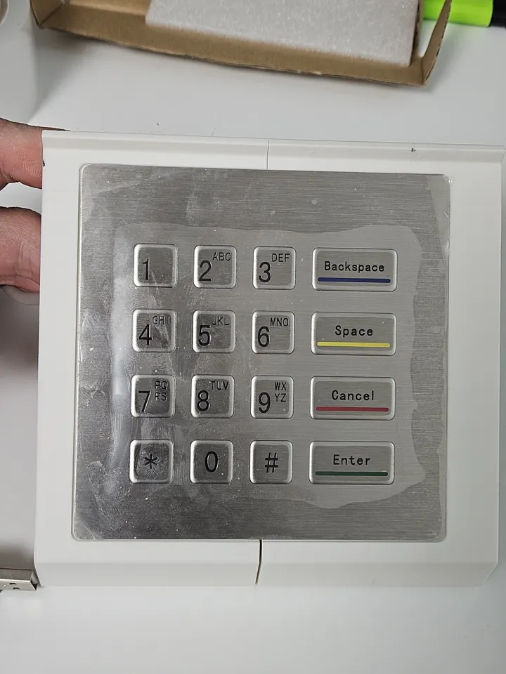 Metal keypad seated in a small white 3D-printed test section.