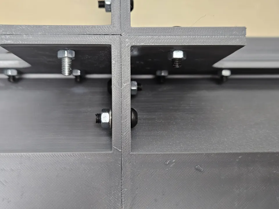 Close-up of bolts, nuts and washers joining internal enclosure flanges.