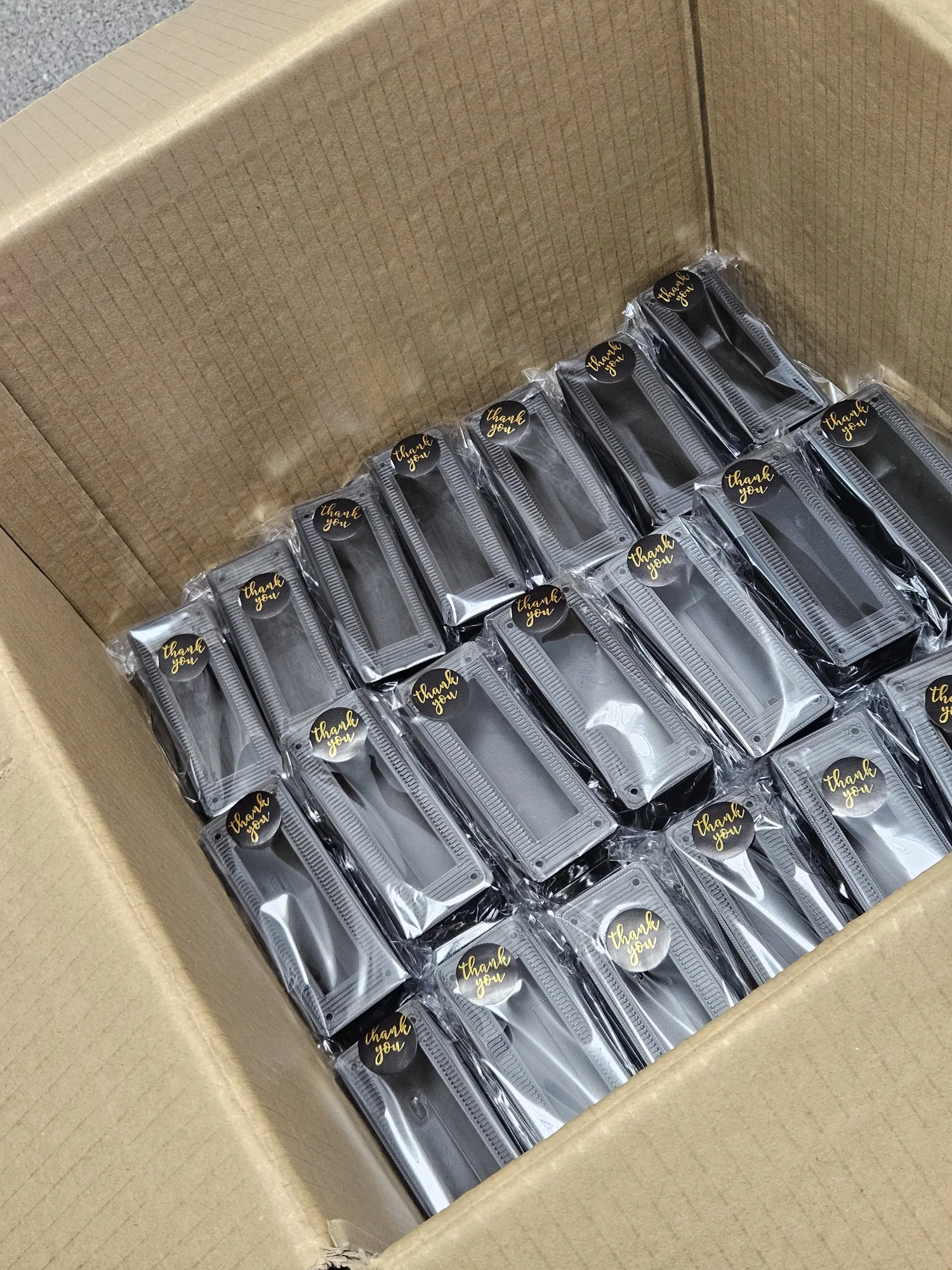 Multiple printed enclosures packed together inside a shipping box.
