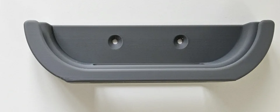Inside face of the grey holder showing its two screw holes.