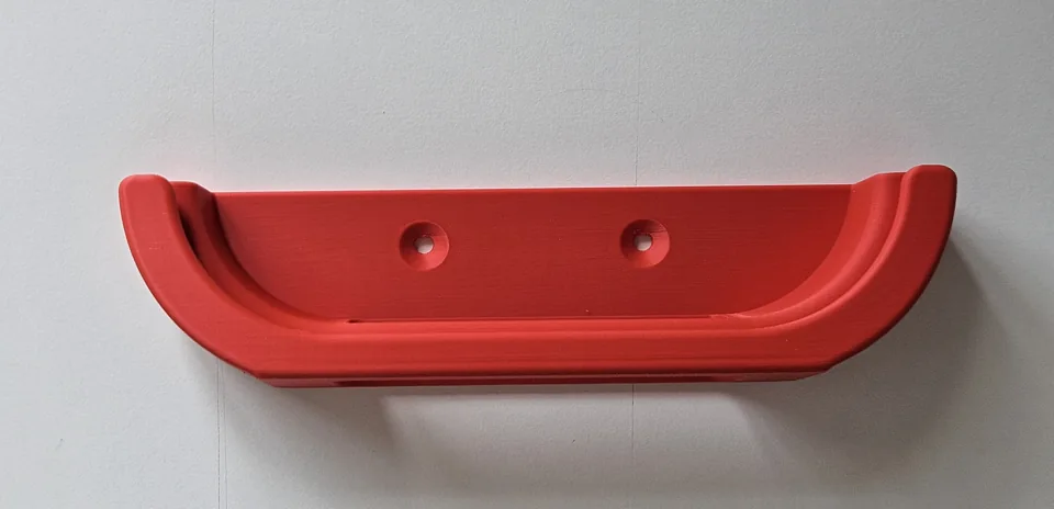 Red printed holder with curved ends and two mounting holes.