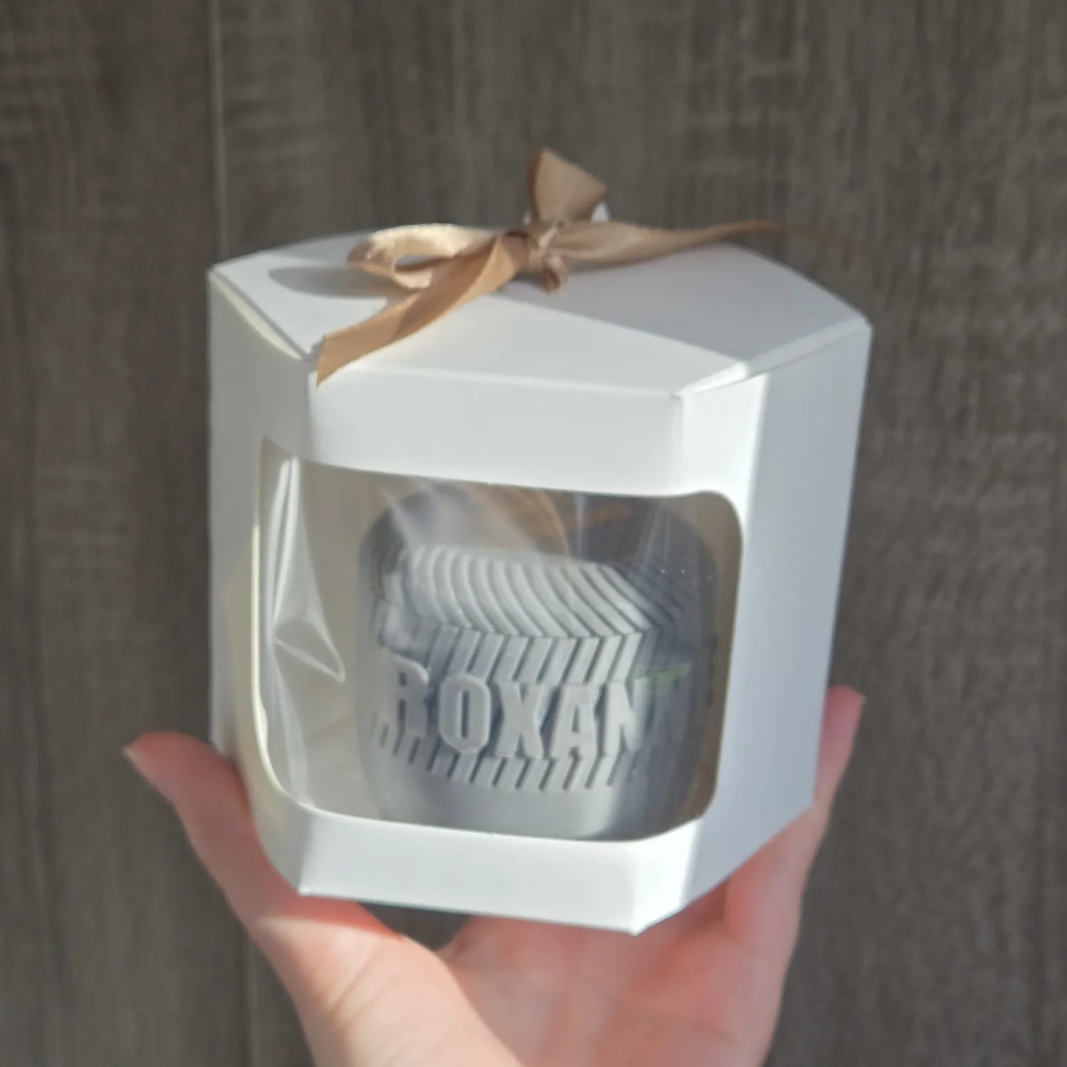 A personalised candle jar presented in gift packaging.