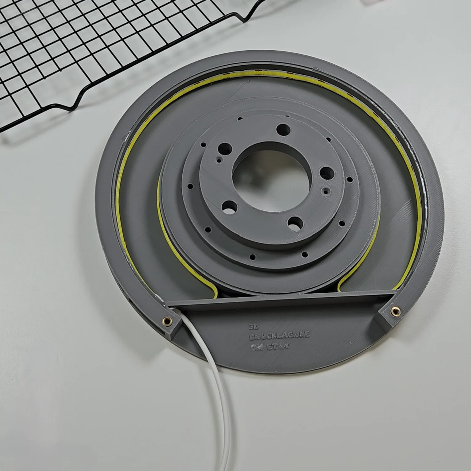 Installing the LED strip into the rear channel of the brake disc lamp.