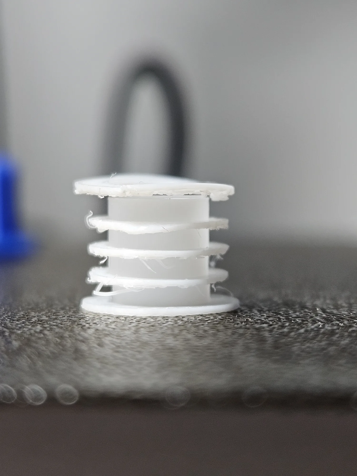 A small FDM-printed coil bobbin prototype showing why the FDM approach was not suitable for the required detail.