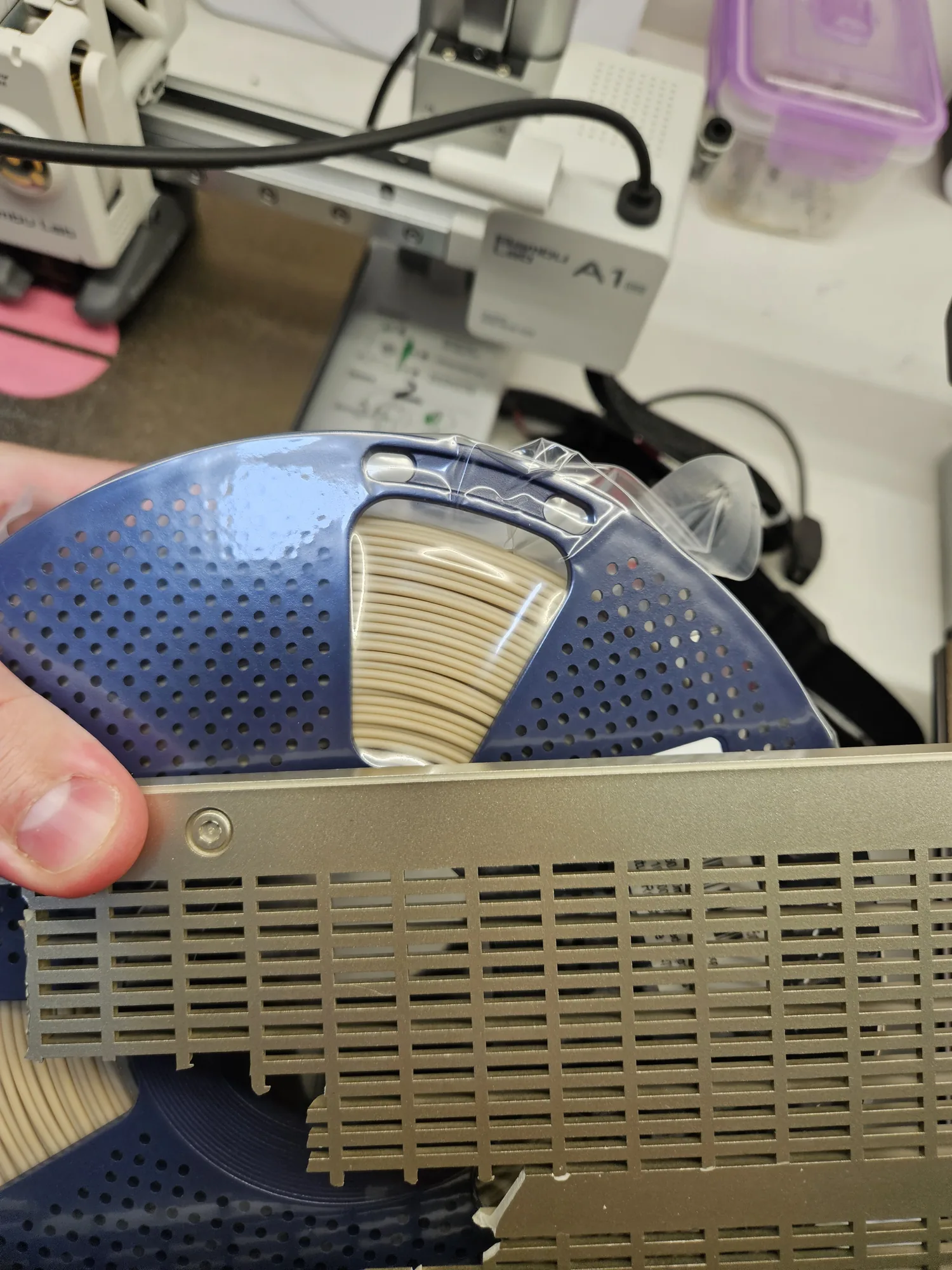 Original radio part shown with a spool of filament used to match the colour.