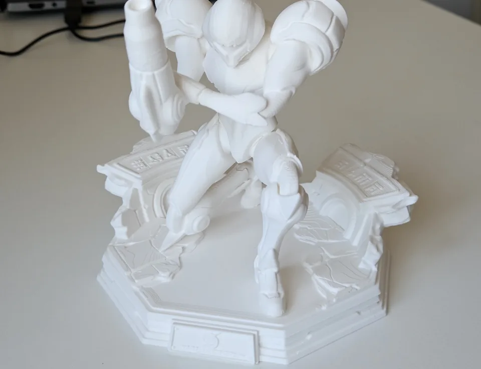Close view of the assembled statue showing armour details, arm cannon and sculpted base.