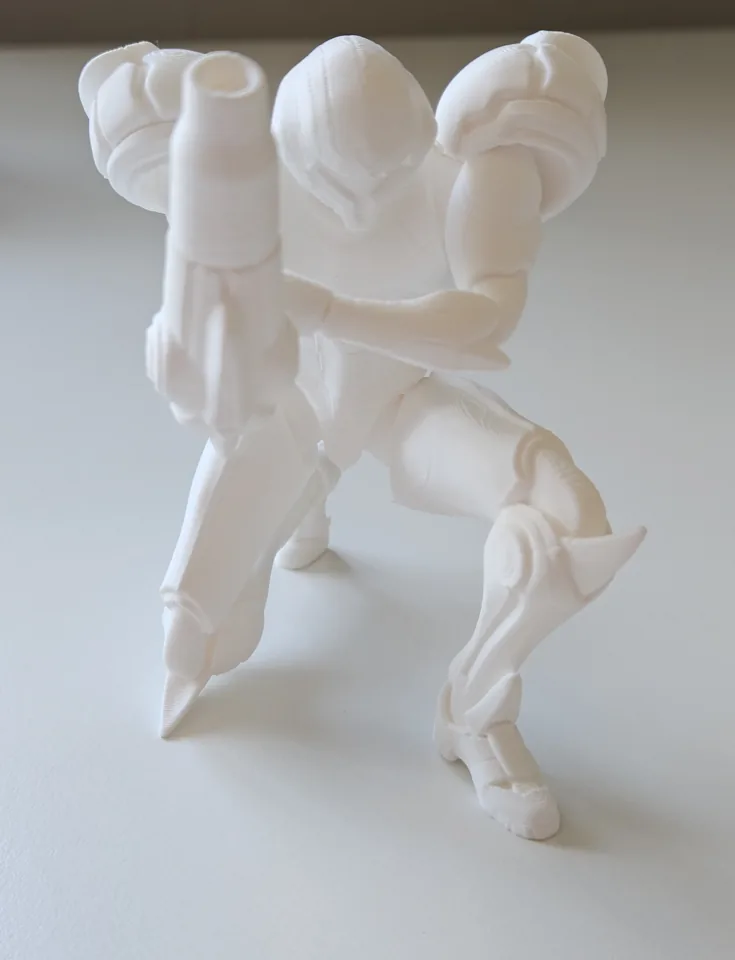 White armoured character with rounded shoulder armour and an arm cannon, without its display base.