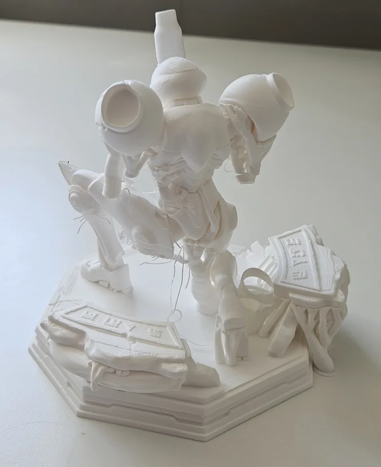 Failed one-piece statue print with loose filament around the lower body and base.