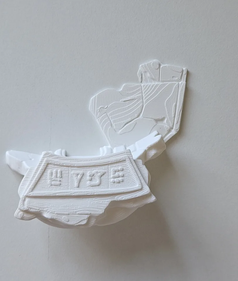 Separate white printed relief section of the statue base.