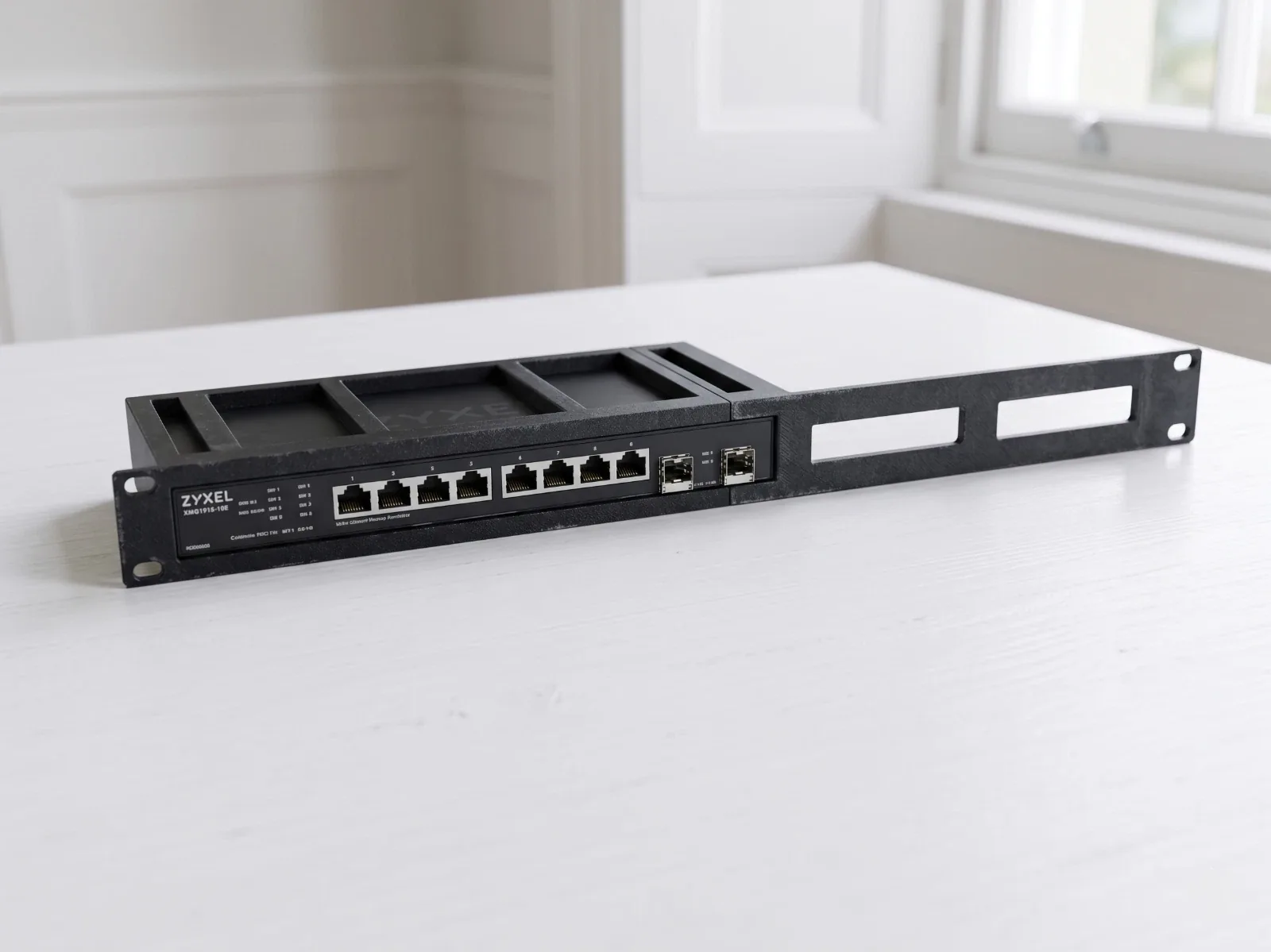 Illustrative view of a Zyxel switch positioned inside the rack adapter.