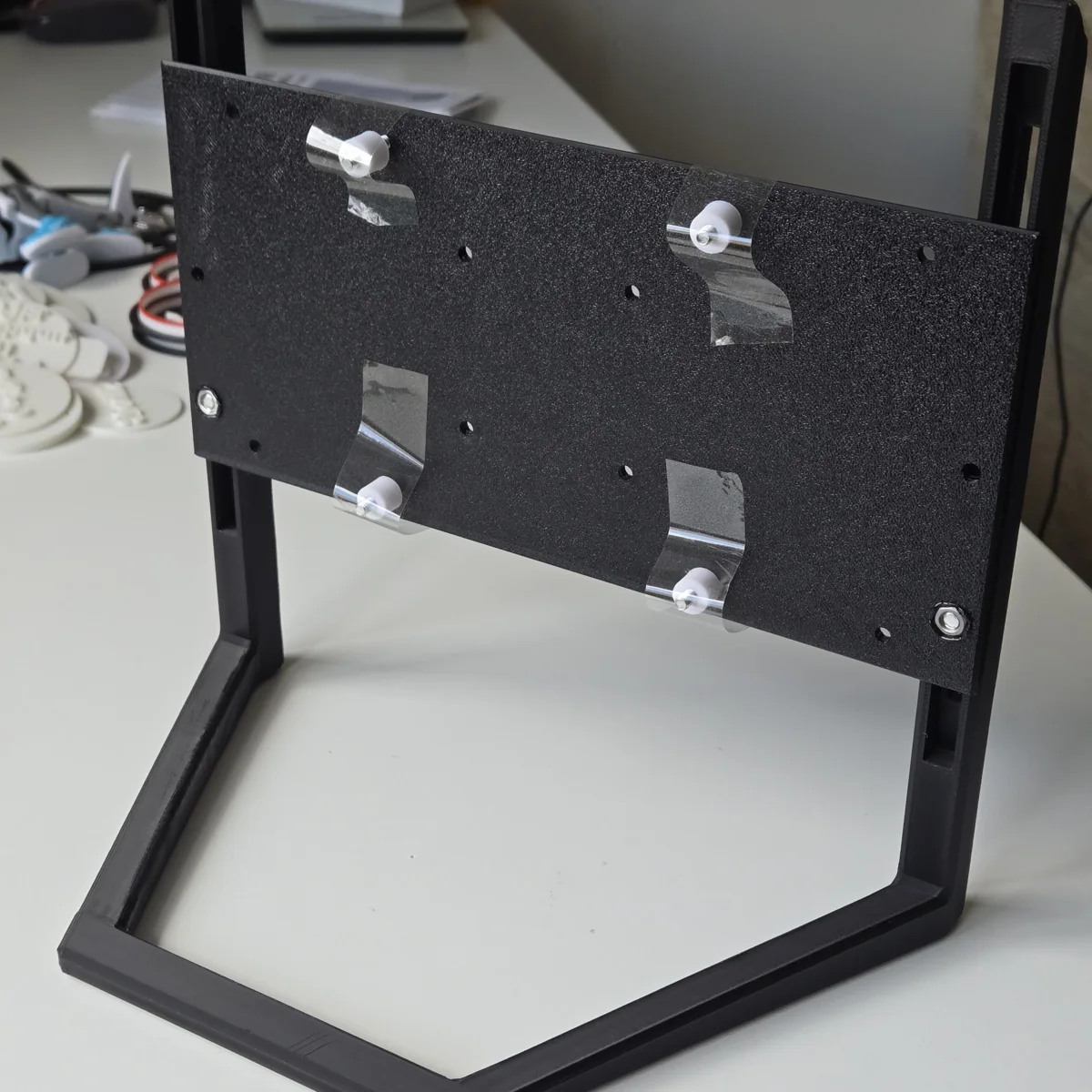 Printed adjustable monitor handle assembled with a mounting plate and metal fasteners.